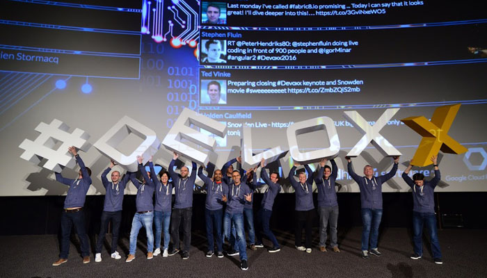 A picture of attendees of the devoxx converence 2022 holding up the letters "devoxx"